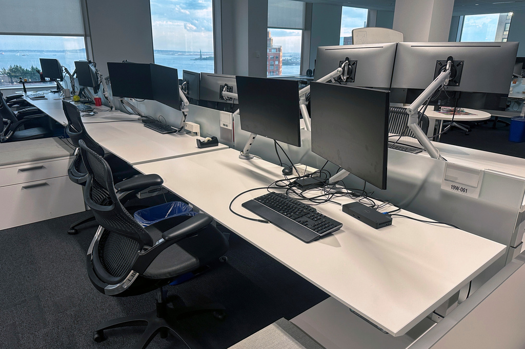 FILE - Empty desks are in an office building in the Manhattan borough of New York on Aug. 2, 2024. (AP Photo/Ted Shaffrey, file)