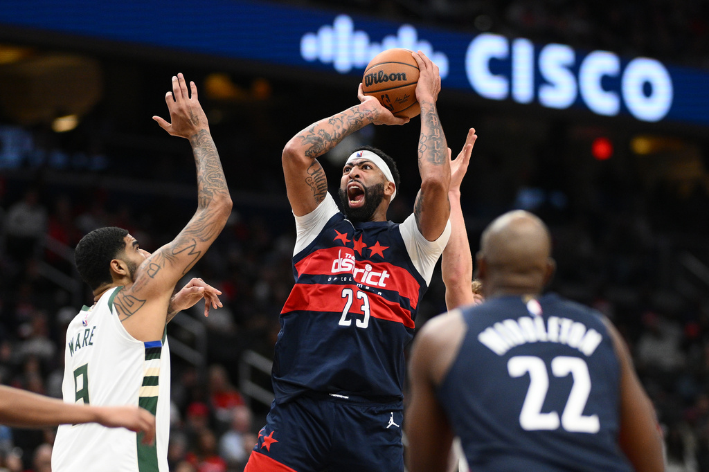 Washington Wizards forward/center Anthony Davis (23) shoots against Milwaukee Bucks center Kel'el Ware (9) during the second half of an NBA basketball game, Wednesday, Oct. 21, 2026, in Washington. (AP Photo/Nick Wass)