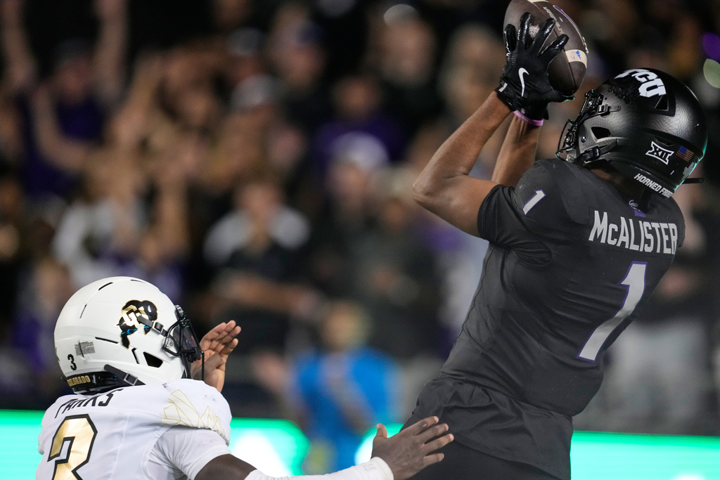 TCU wide receiver Eric McAlister (1) catches a touchdown pass as Colorado defensive back Teon Parks (3) defends in the second half of an NCAA college football game Saturday, Oct. 4, 2025, in Fort Worth, Texas. (AP Photo/Tony Gutierrez)