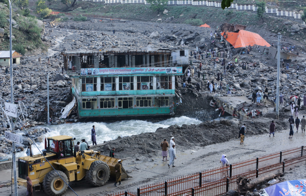 Residents and rescue workers inspect buildings damaged by heavy flooding in the eastern province of Nuristan, Afghanistan, Tuesday, July 21, 2026. (AP Photo/Wahidullah Kakar)