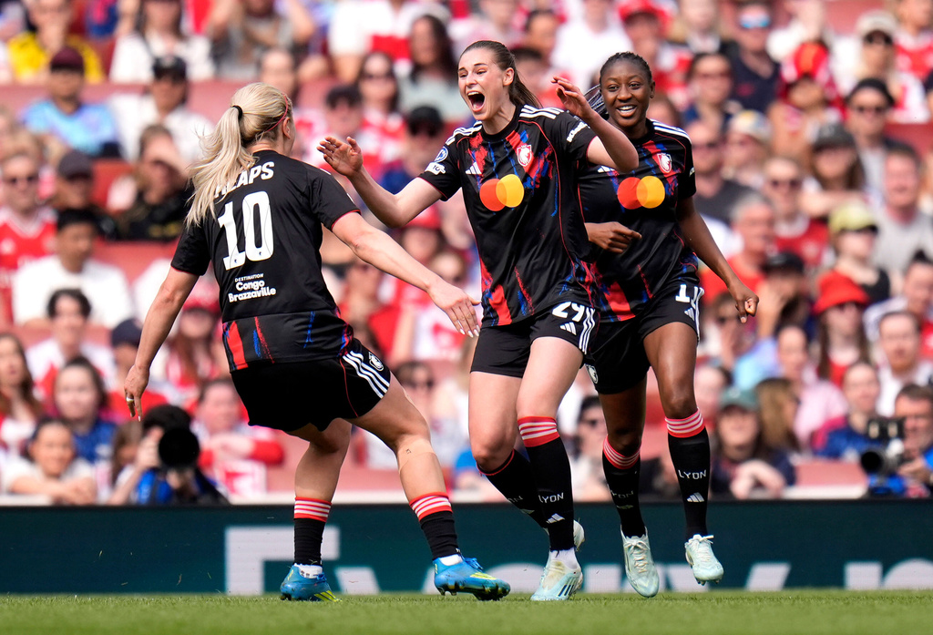 OL Lyonnes' Jule Brand, center, celebrates after scoring the opening goal during the Women's Champions League semi-final, first leg soccer match between Arsenal and OL Lyonnes in London, England, Sunday April 26, 2026. (Andrew Matthews/PA via AP)