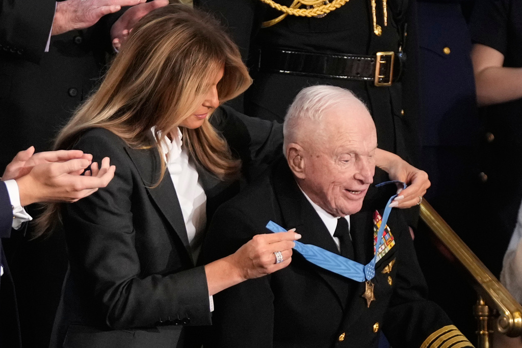 First lady Melania Trump awards World War II Navy pilot Capt. Royce Williams the Congressional Medal of Honor as President Donald Trump delivers the State of the Union address to a joint session of Congress in the House chamber at the U.S. Capitol in Washington, Tuesday, Feb. 24, 2026. (AP Photo/Mark Schiefelbein)
