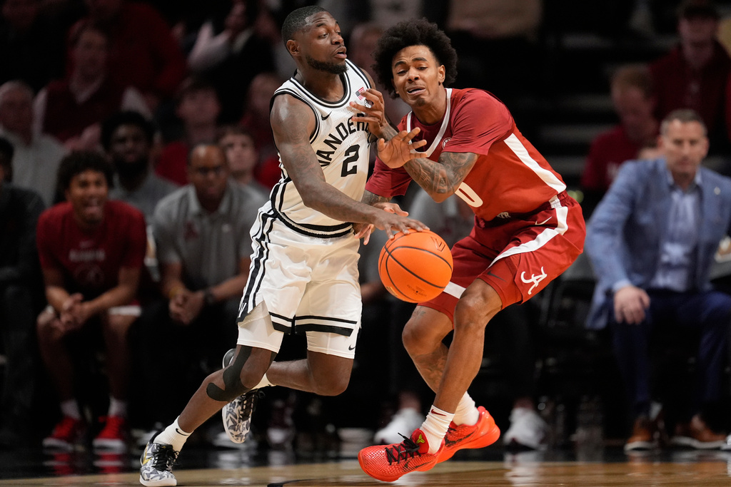 Vanderbilt guard Duke Miles (2) dribbles the ball past Alabama guard Labaron Philon (0) during the first half of an NCAA college basketball game Wednesday, Jan. 7, 2026, in Nashville, Tenn. (AP Photo/George Walker IV)