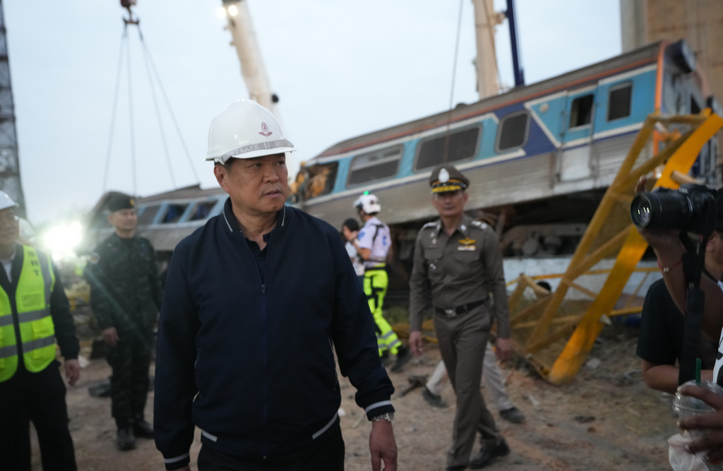 Thailand's Prime Minister Anutin Charnvirakul visits the site where a construction crane fell onto a passenger train in Nakhon Ratchasima province, Thailand, Wednesday, Jan. 14, 2026. (AP Photo/Sakchai Lalit)