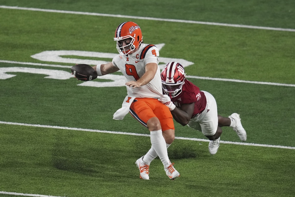 Illinois quarterback Luke Altmyer (9) is tackled by Indiana linebacker Rolijah Hardy (21) during the first half of an NCAA college football game, Saturday, Sept. 20, 2025, in Bloomington, Ind. (AP Photo/Darron Cummings)