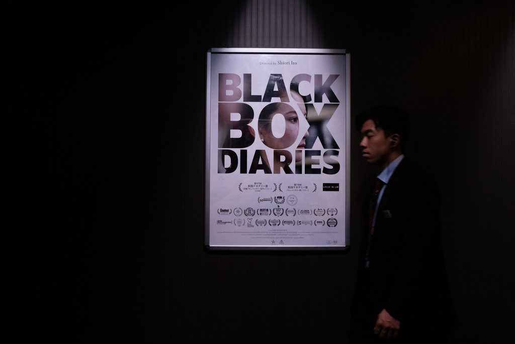 A cinema staff member walks past a poster for "Black Box Diaries" on the day of the film's Japan premiere at a cinema in Tokyo, Friday, Dec. 12, 2025. (AP Photo/Louise Delmotte)
