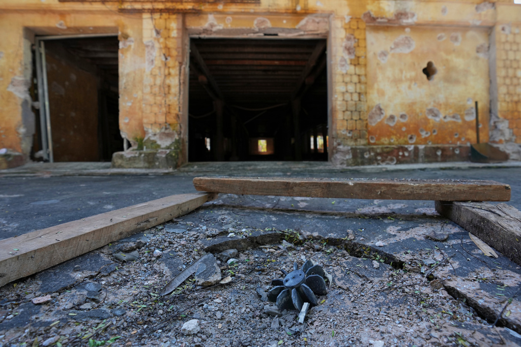 In this photo taken during a trip supervised by pro-military Myanmar media, an exploded ordnance lies in the ground in Kyaukme, northern Shan State, Myanmar, Friday, Oct. 10, 2025. (AP Photo/Aung Shine Oo)