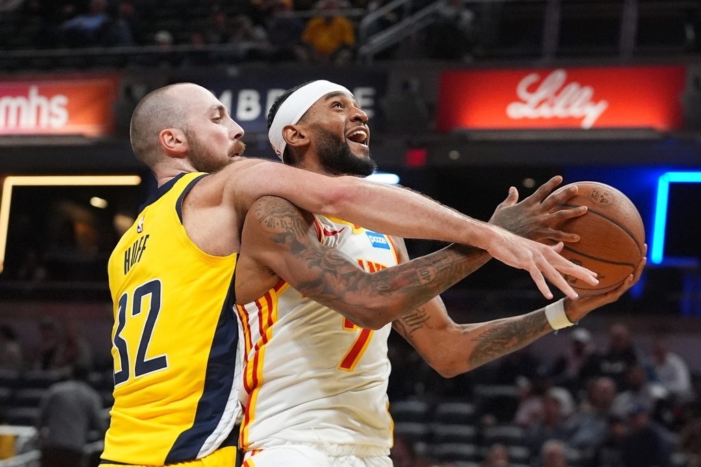 Atlanta Hawks' Nickeil Alexander-Walker (7) if fouled by Indiana Pacers' Jay Huff (32) during the second half of an NBA Cup basketball game, Friday, Oct. 31, 2025, in Indianapolis. (AP Photo/Darron Cummings)