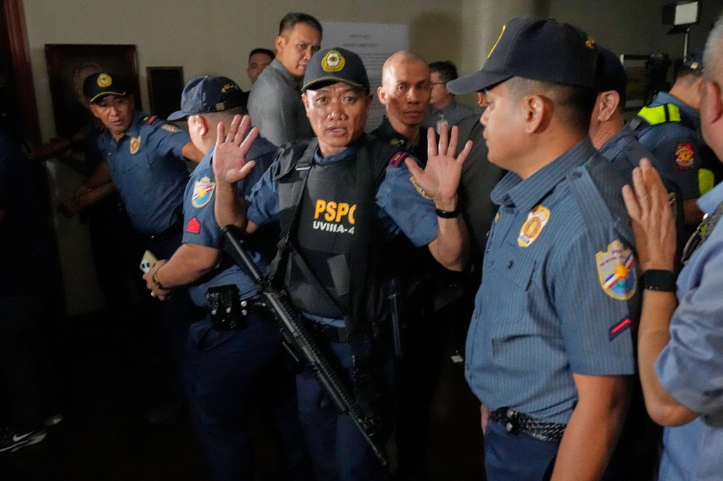Police clear the area of the media as gunshots were heard at the Philippine Senate in Pasay, Philippines on Wednesday, May 13, 2026. (AP Photo/Aaron Favila)
