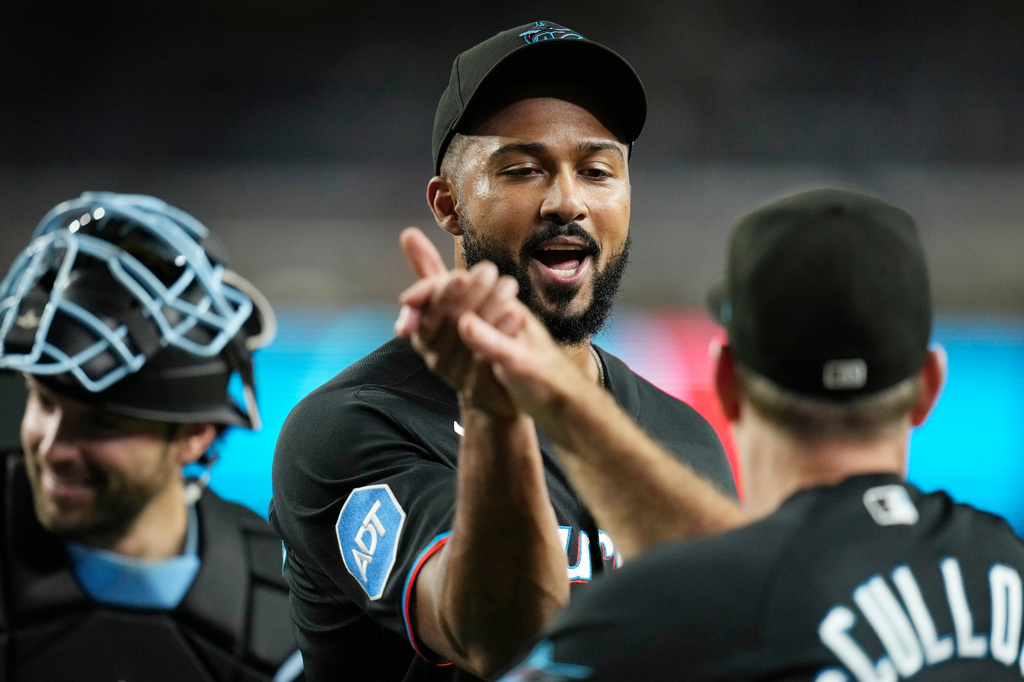 Miami Marlins pitcher Sandy Alcantara, left, celebrates a win against the Arizona Diamondbacks with Marlins manager Clayton McCullough after a baseball game, Wednesday, Sept. 16, 2026, in Phoenix. (AP Photo/Ross D. Franklin)
