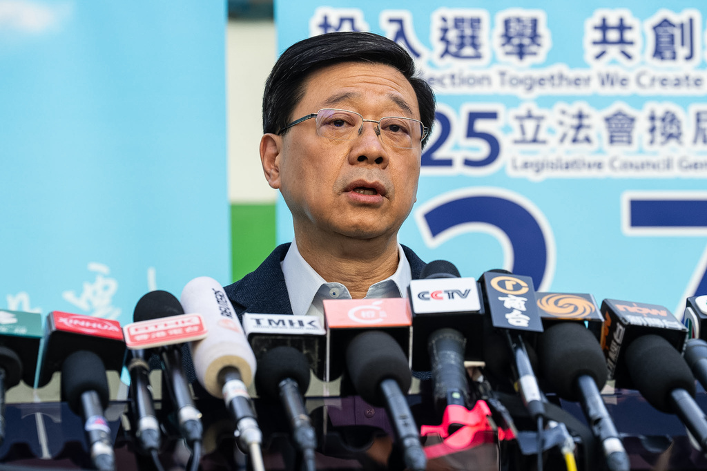 Hong Kong's Chief Executive John Lee speaks to the media at a polling station during the Legislative Council General Election in Hong Kong on Sunday, Dec. 7, 2025. (AP Photo/Chan Long Hei)