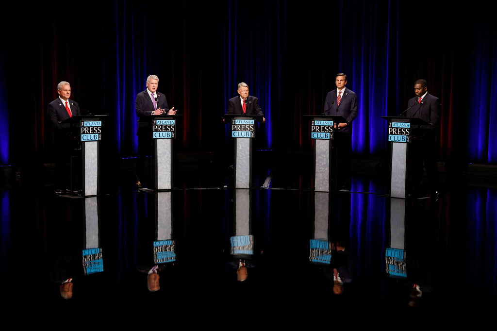 U.S. Rep. Mike Collins, R-Jackson, second left, speaks at the Atlanta Press Club Loudermilk-Young primary election debate for the U.S. Senate at Georgia Public Broadcasting, Sunday, April 26, 2026, in Midtown Atlanta. (Miguel Martinez/Atlanta Journal-Constitution via AP)