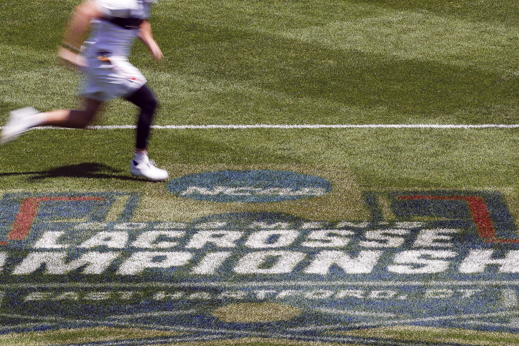 FILE - A player runs on the field before a NCAA college men's lacrosse championship game, May 30, 2022, in East Hartford, Conn. (AP Photo/Bryan Woolston, file)
