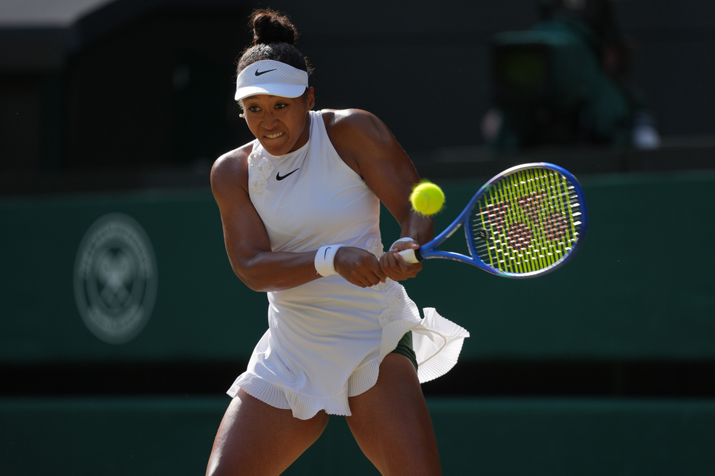 Naomi Osaka of Japan returns the ball to Karolina Muchova of Czech Republic in their quarter-final women's singles match at the Wimbledon Tennis Championships in London, Tuesday, July 7, 2026. (AP Photo/Kin Cheung)