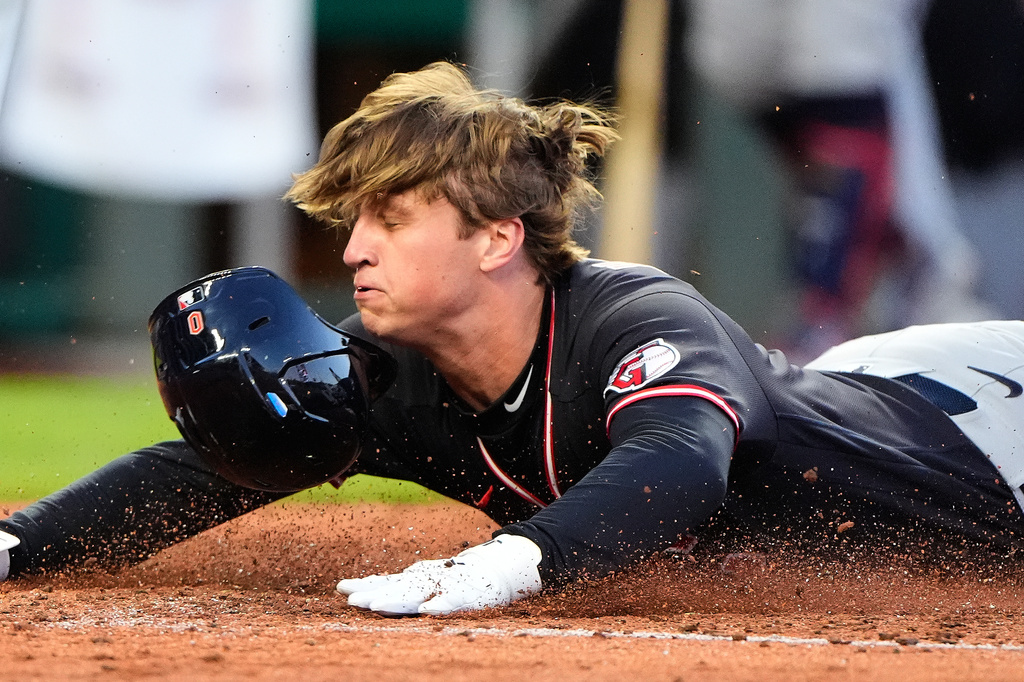 Cleveland Guardians' Petey Halpin slides home to score on a two-run single hit by Chase DeLauter during the fifth inning of a baseball game against the Kansas City Royals, Wednesday, May 6, 2026, in Kansas City, Mo. (AP Photo/Charlie Riedel)
