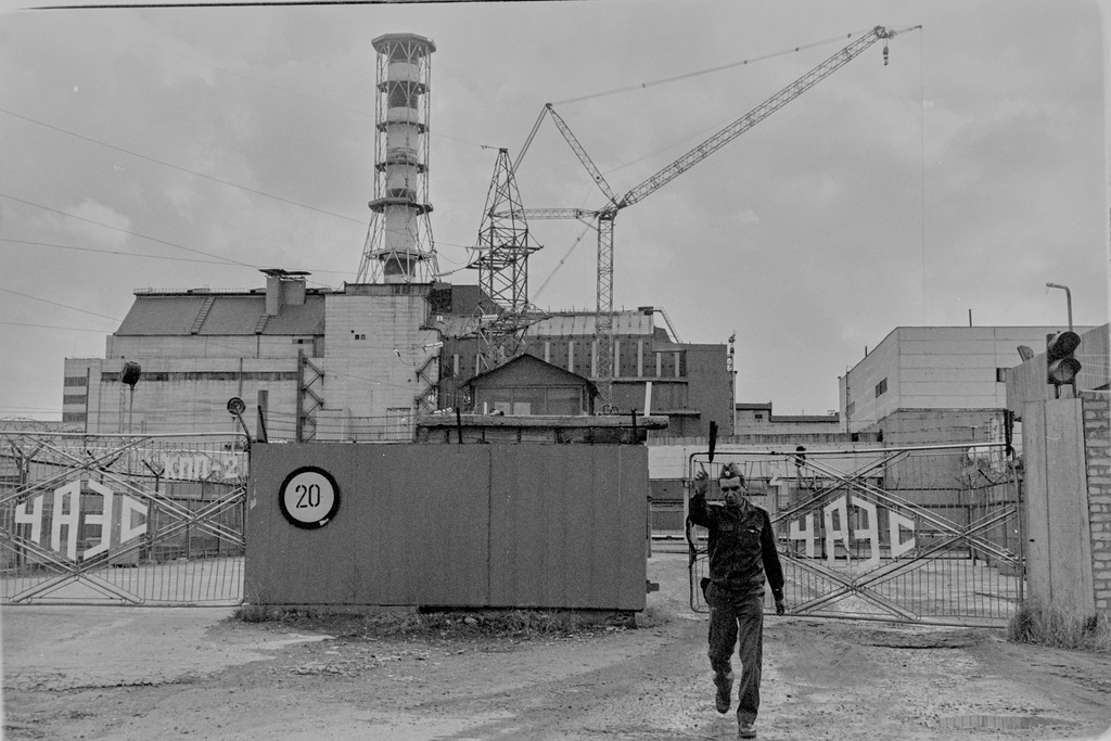 A security officer gestures to a photographer outside the gates of the Chernobyl nuclear power plant in this 1989 photo, in Chernobyl, Ukraine. (AP Photo/Efrem Lukatsky)