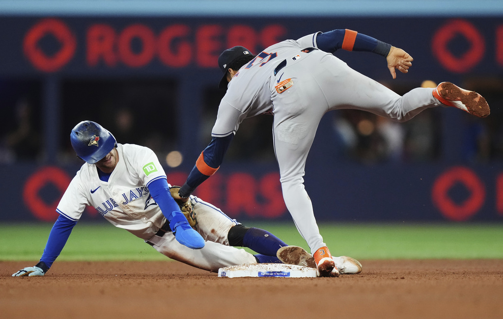 Toronto Blue Jays' Ernie Clement (left) is tagged out by Houston Astros shortstop Jeremy Pena (3) trying to steal second base during fifth inning MLB baseball action in Toronto on Wednesday, Sept. 10, 2025. (Nathan Denette/The Canadian Press via AP)
