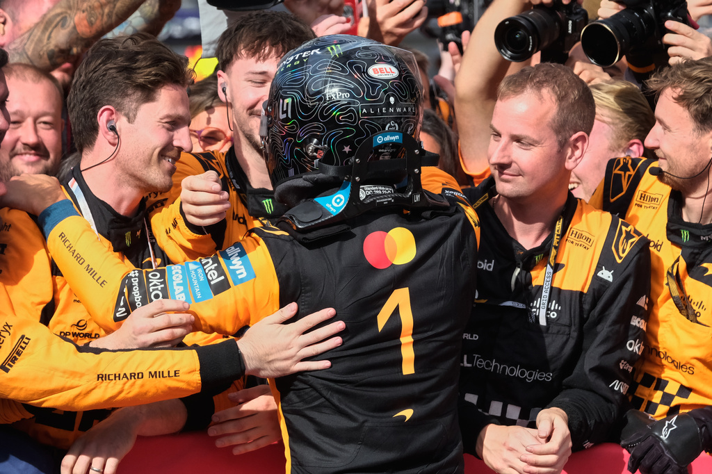 McLaren driver Lando Norris of Britain celebrates with his team after winning the Formula One Dutch Grand Prix in Zandvoort , Netherlands, Sunday, Aug. 23, 2026. (AP Photo/Patrick Post)