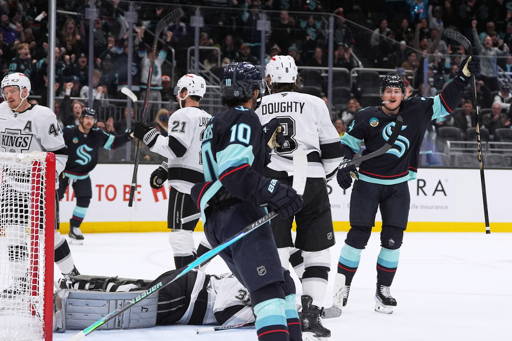Seattle Kraken center Bobby McMann, right, celebrates scoring against the Los Angeles Kings during the third period of an NHL hockey game Monday, April 13, 2026, in Seattle. (AP Photo/Lindsey Wasson)