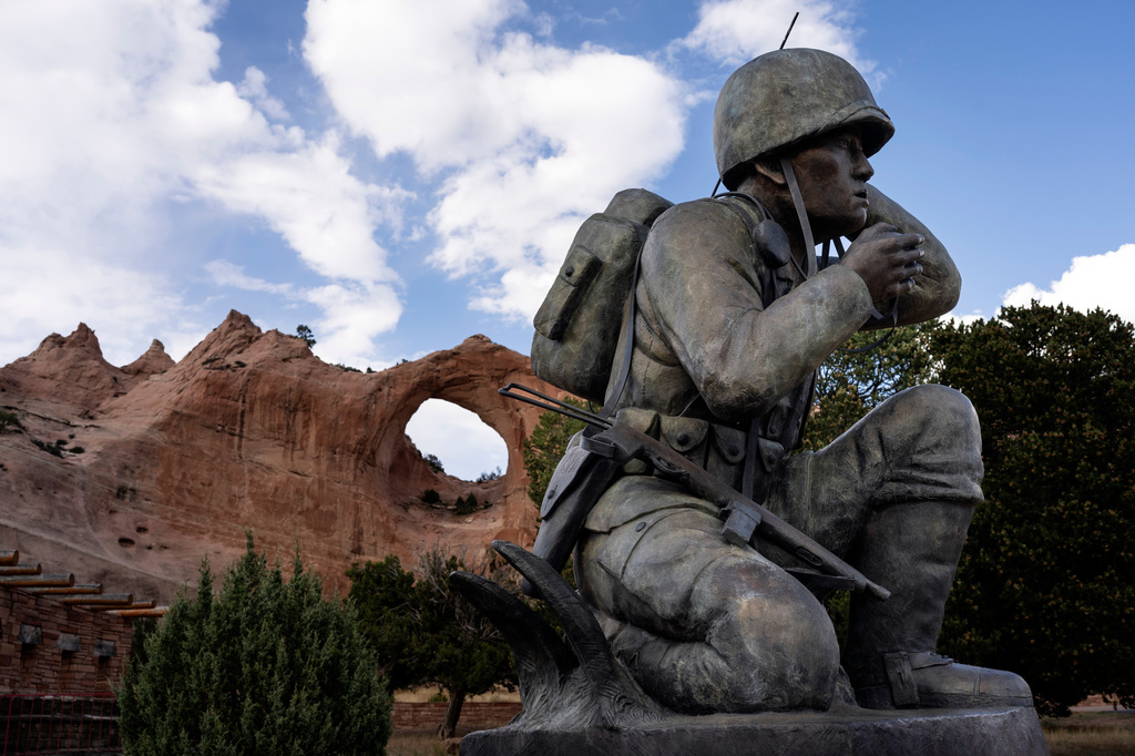 FILE - A monument to the Navajo Code Talkers stands in front of the red sandstone arch of Window Rock, Ariz., outside the Navajo Nation government headquarters, Oct. 10, 2024. (AP Photo/Rodrigo Abd, File)