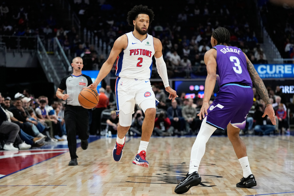Detroit Pistons guard Cade Cunningham, left, drives against Utah Jazz guard Keyonte George during the first half of an NBA basketball game Wednesday, Nov. 5, 2025, in Detroit. (AP Photo/Ryan Sun)