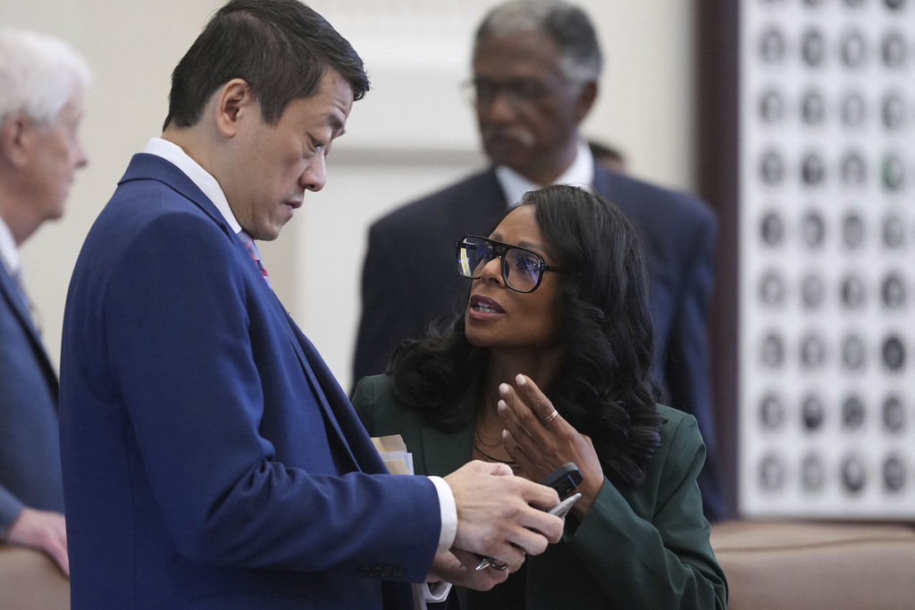 Democratic lawmakers Texas Rep. Gene Wu, left, and Rep. Nicole Collier, right, talk before a debate on a redrawn U.S. congressional map in Texas during a special, Wednesday, Aug. 20, 2025, in Austin, Texas. (AP Photo/Eric Gay)