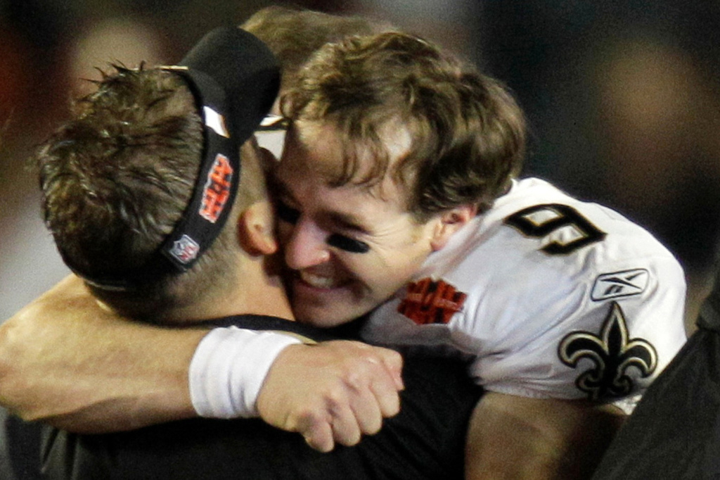 FILE - New Orleans Saints quarterback Drew Brees (9) hugs head coach Sean Payton after the Saints won the NFL Super Bowl XLIV football game in Miami, Feb. 7, 2010. (AP Photo/Chuck Burton, File)