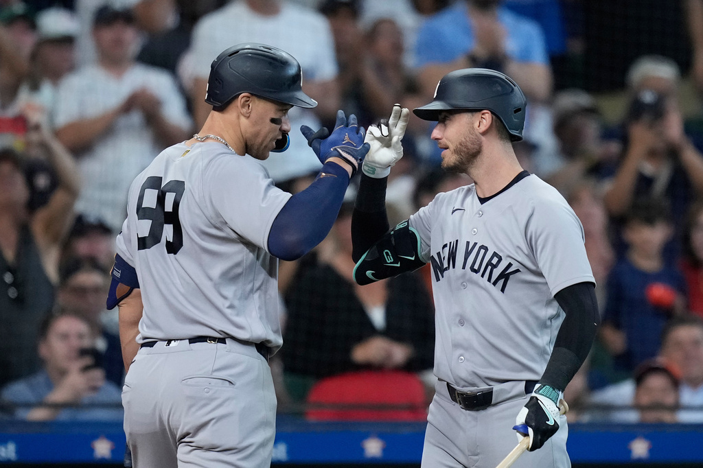 New York Yankees' Aaron Judge, left, celebrates with Cody Bellinger, right, after hitting a solo home run during the sixth inning of a baseball game against the Houston Astros, Sunday, April 26, 2026, in Houston. (AP Photo/Kevin M. Cox)