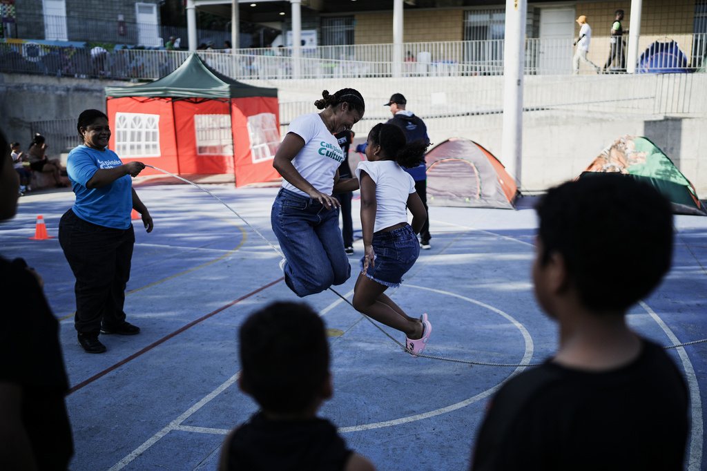 Girls jump rope at a park where people evacuated from their earthquake-damaged homes are camping three days after a quake hit Cali, Colombia, Thursday, Aug. 13, 2026. (AP Photo/Ivan Valencia)
