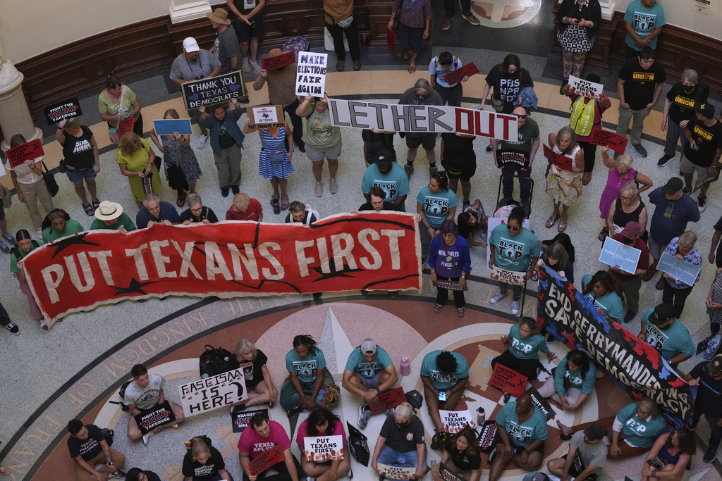 Protesters gather in the rotunda outside the House Chamber at the Texas Capitol as lawmakers debate a redrawn U.S. congressional map in Texas during a special session, Wednesday, Aug. 20, 2025, in Austin, Texas. (AP Photo/Eric Gay)