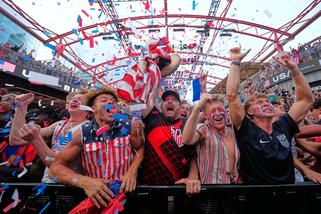Fans cheer during a watch party for a World Cup soccer match between the United States and Bosnia at the KC Live! entertainment district Wednesday, July 1, 2026, in Kansas City, Mo. (AP Photo/Charlie Riedel)