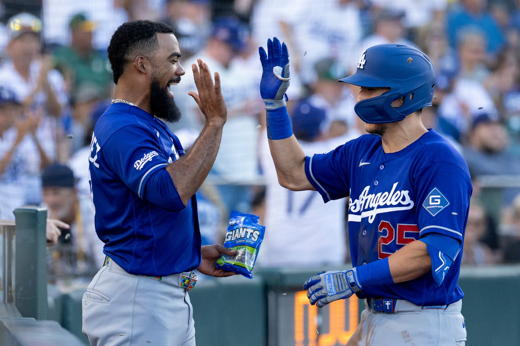Los Angeles Dodgers' Tommy Edman, right, celebrates with Teoscar Hernández after hitting a three-run home run during the third inning of a baseball game against the Athletics Tuesday, June 30, 2026, in West Sacramento, Calif. (AP Photo/Sara Nevis)