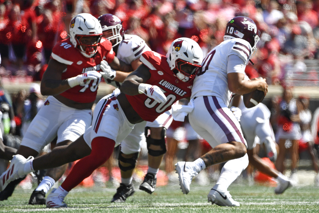 Louisville defensive lineman Clev Lubin (50) tackles Eastern Kentucky quarterback Myles Burkett (10) during the first half of an NCAA college football game in Louisville, Ky., Saturday, Aug. 30, 2025. (AP Photo/Timothy D. Easley)