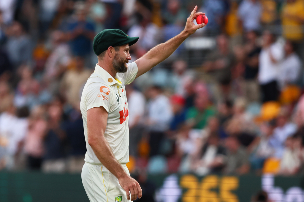 Australia's Michael Neser shows the ball after getting five wickets during the second Ashes cricket test match between Australia and England in Brisbane, Sunday, Dec. 7, 2025.. (AP Photo/Tertius Pickard)