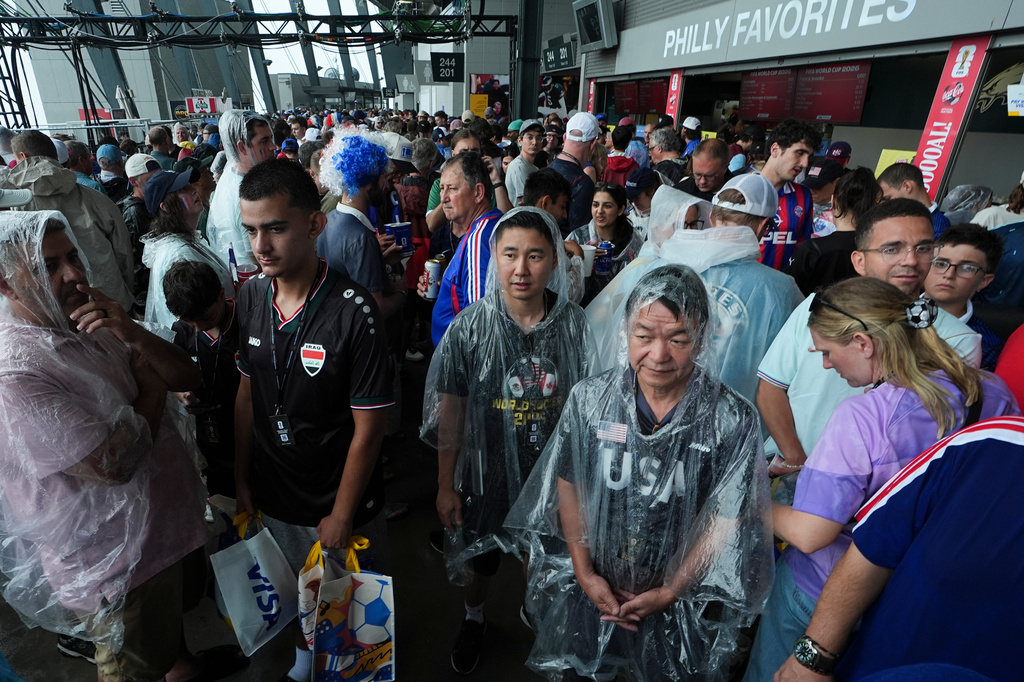 Fans wait in a sheltered area of the stadium as bad weather halts play during the World Cup Group I soccer match between France and Iraq in Philadelphia, Monday, June 22, 2026. (AP Photo/Matt Rourke)
