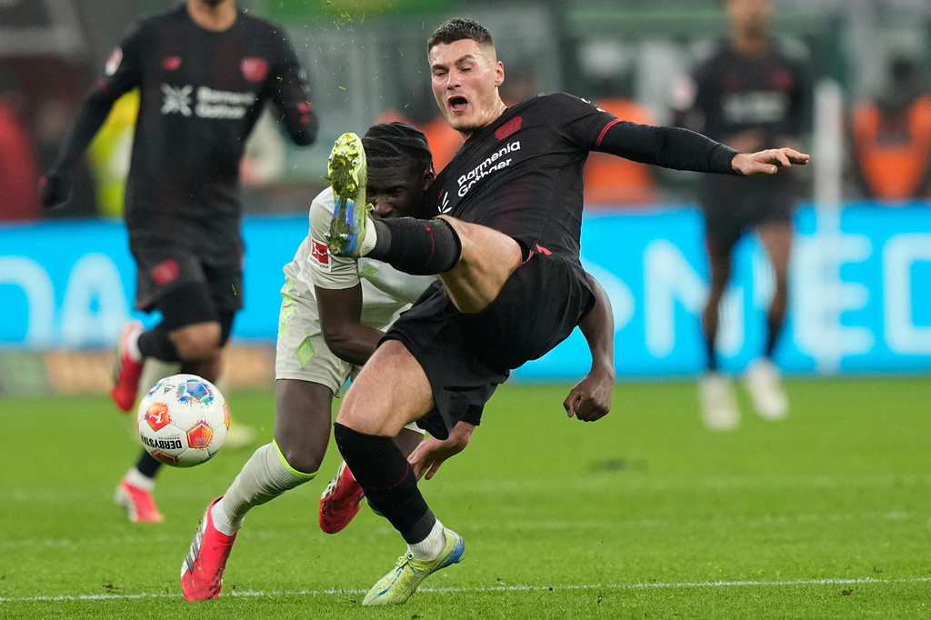 Leverkusen's Patrik Schick challenges for the ball with Bremen's Karim Coulibaly during the German Bundesliga soccer match between Bayer Leverkusen and Werder Bremen in Leverkusen, Germany, Saturday, Jan. 24, 2026. (AP Photo/Martin Meissner)