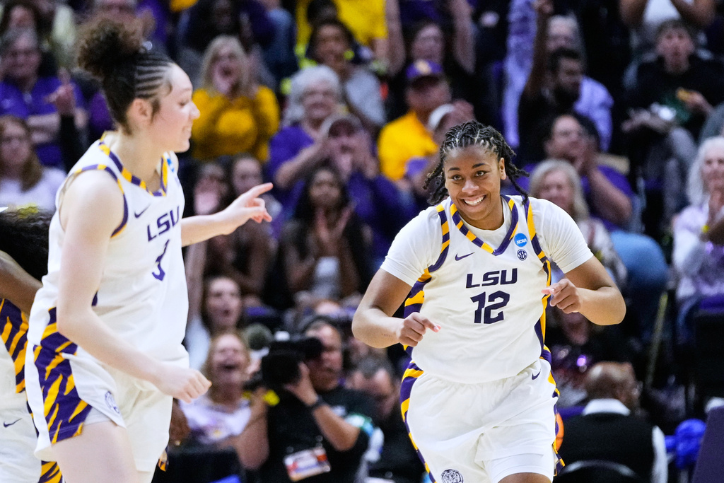 LSU guard Mikaylah Williams (12) and guard Bella Hines (3) celebrate a basket against Jacksonville during the second half in the first round of the NCAA college basketball tournament, Friday, March 20, 2026, in Baton Rouge, La. (AP Photo/Gerald Herbert)