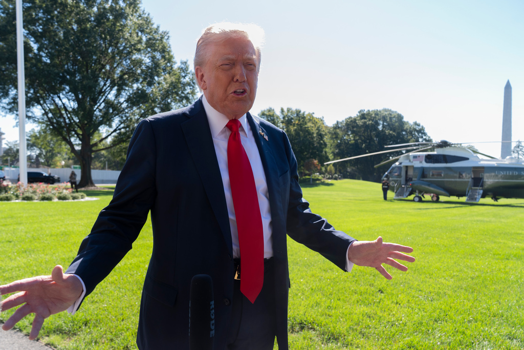 President Donald Trump speaks to reporters before departing the White House, en route Norfolk, Va., to observe a naval sea power demonstration, Sunday, Oct. 5, 2025, in Washington. (AP Photo/Manuel Balce Ceneta)