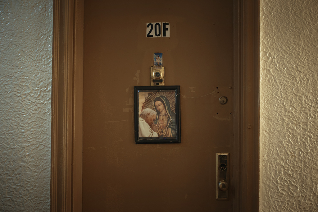 A religious image hangs from a front door in an apartment building where tenants report maintenance issues and pest infestations, in the Bronx borough of New York, Tuesday, March 17, 2026. (AP Photo/Andres Kudacki)