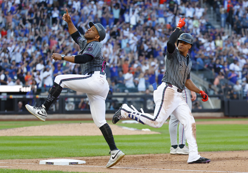 New York Mets first base coach Antoan Richardson, left, reacts after a home run by Juan Soto, right, during the sixth inning of a baseball game against the Miami Marlins, Saturday, Aug. 30, 2025, in New York. (AP Photo/Noah K. Murray)