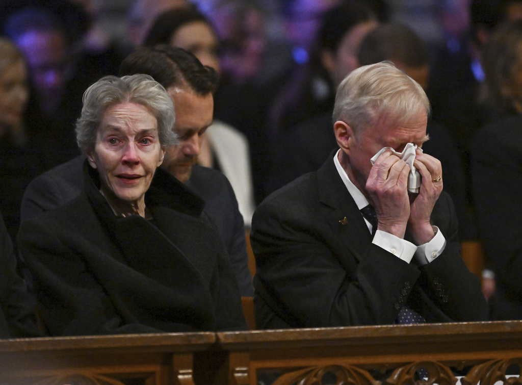 Jack Carter, right, and his wife Liz react during the state funeral of former President Jimmy Carter at the National Cathedral, Thursday, Jan. 9, 2025, in Washington. (Ricky Carioti/The Washington Post via AP, Pool)