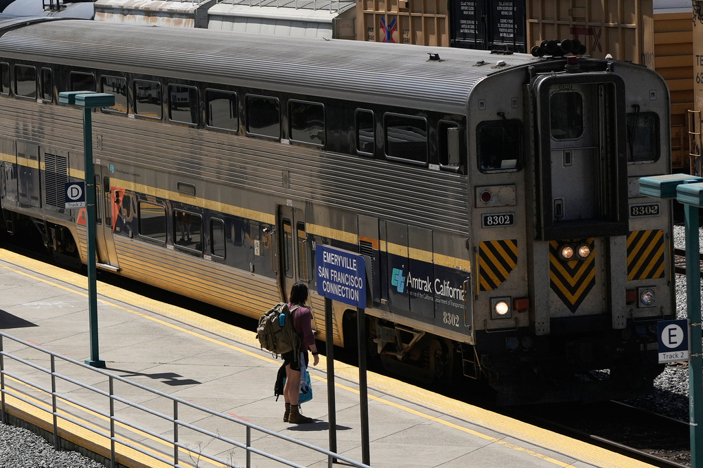 A passenger waits to board an Amtrak train at a station in Emeryville, Calif., Thursday, April 30, 2026. (AP Photo/Jeff Chiu)