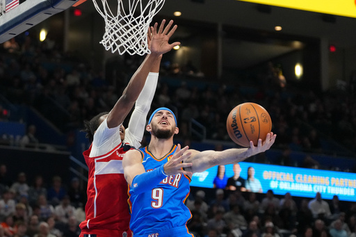 Oklahoma City Thunder guard Alex Caruso, right, shoots around Washington Wizards guard Bub Carrington, left, during the second half of an NBA basketball game, Thursday, Oct. 30, 2025, in Oklahoma City. (AP Photo/Kyle Phillips) Oklahoma City Thunder guard Alex Caruso, right, shoots around Washington Wizards guard Bub Carrington, left, during the second half of an NBA basketball game, Thursday, Oct. 30, 2025, in Oklahoma City. (AP Photo/Kyle Phillips)