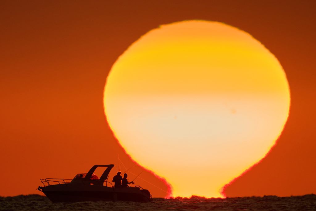 Fishermen are silhouetted aboard a boat as the sun sets over the Mediterranean Sea in Beirut, Lebanon, Thursday, Oct. 8, 2026. (AP Photo/Hassan Ammar)