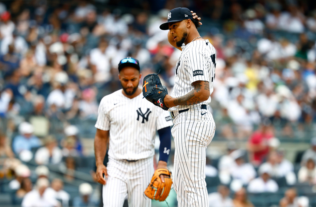 New York Yankees pitcher Camilo Doval, right, reacts after giving up runs to the Minnesota Twins during the sixth inning of a baseball game, Sunday, July 5, 2026, in New York. (AP Photo/Noah K. Murray)