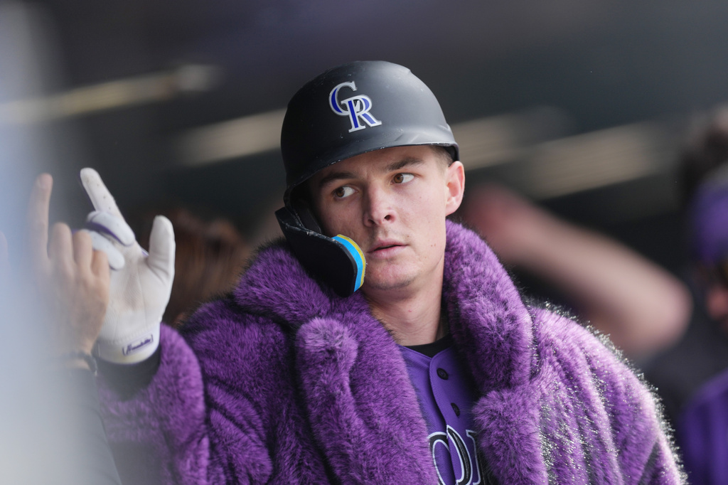 Colorado Rockies' Mickey Moniak is congratulated as he returns to the dugout after hitting a two-run home run off Atlanta Braves relief pitcher Aaron Bummer in the fourth inning of a baseball game, Sunday, May 3, 2026, in Denver. (AP Photo/David Zalubowski)