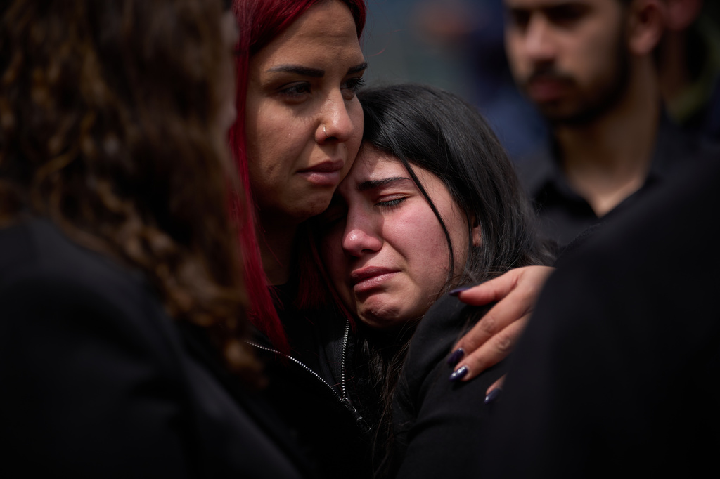 Relatives react as the coffins with the bodies of Pierre Mouawad, an official with the anti-Hezbollah Lebanese Forces party, and his wife are carried during their funeral in Yahshush, in Lebanon, Tuesday, April 7, 2026. (AP Photo/Emilio Morenatti)