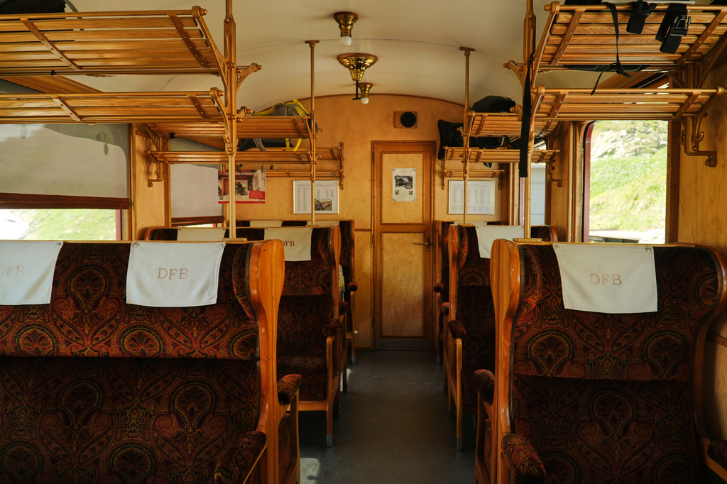 Interior view of a historic passenger carriage in service on the Furka railway during a stop at the Furka station near Realp, Switzerland, Friday, June 26, 2026. (AP Photo/Niccolo Lupone)