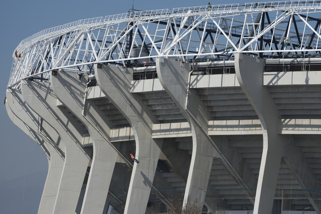 A worker paints a column of the Azteca Stadium 100 days before the opening ceremony of the 2026 FIFA soccer World Cup in Mexico City, Tuesday, March 3, 2026. (AP Photo/Fernando Llano)
