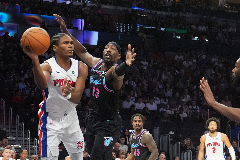 Miami Heat center Bam Adebayo (13) attempts to block a pass by Detroit Pistons guard Ausar Thompson (9) during the first half of an NBA basketball game Saturday, Nov. 29, 2025, in Miami. (AP Photo/Marta Lavandier)
